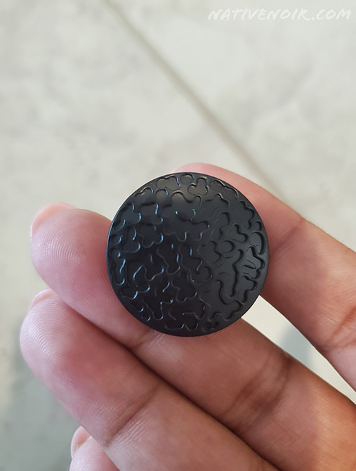 Holding a black round knob used on the DIY mudroom entry wall