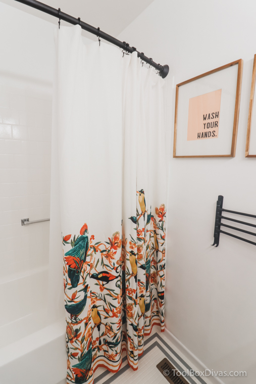 colorful shower curtain with birds and wall art